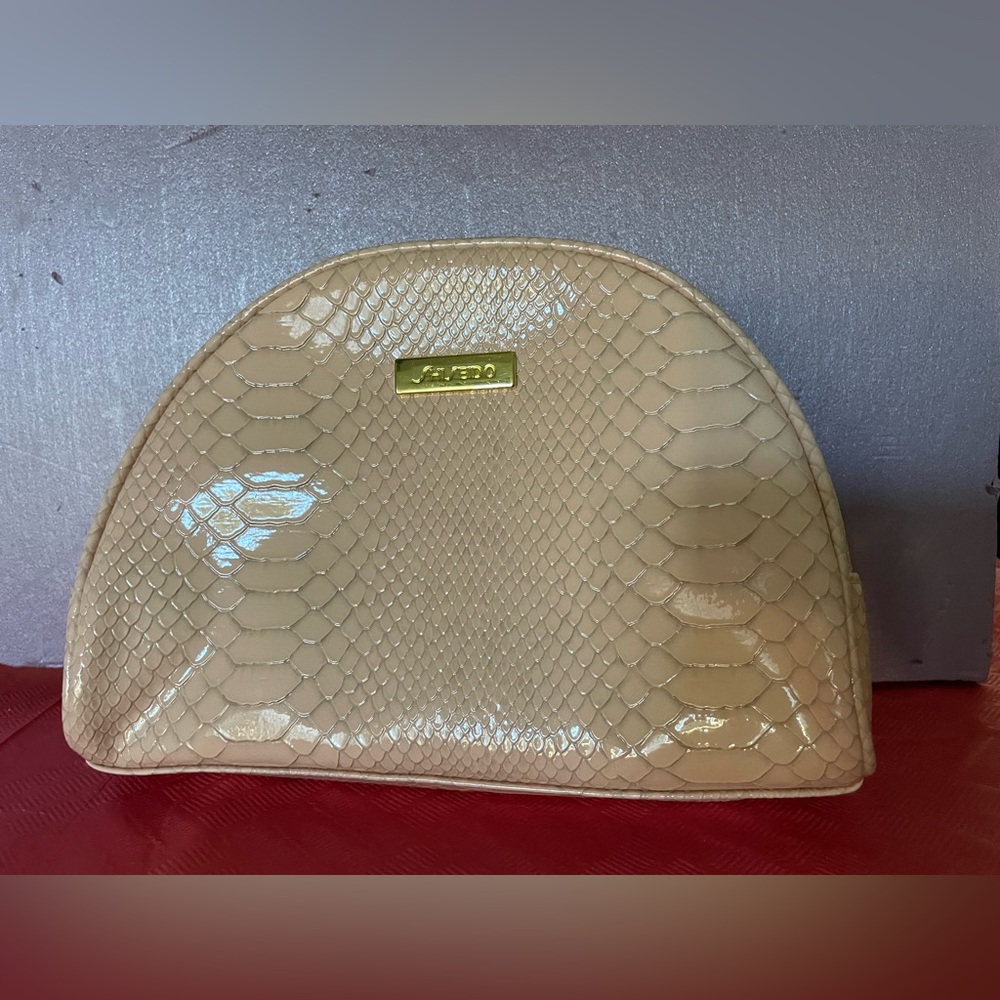 Shiseido cosmetics zip around bag. Color: peach/pink